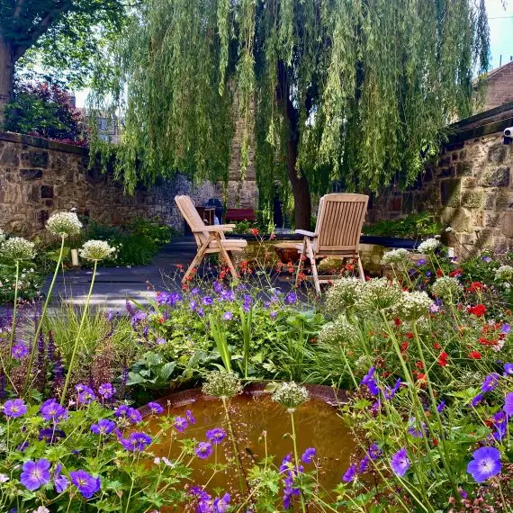 Herbaceous planting, corten water bowl and seating area