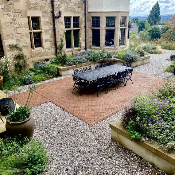Oxleys dining table and chairs in courtyard garden